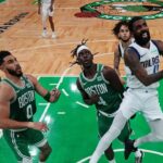 Dallas Mavericks guard Kyrie Irving (11) shoots the ball against Boston Celtics guard Jrue Holiday (4) in game five of the 2024 NBA Finals at TD Garden.