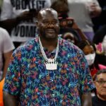 Former NBA player Shaquille O'Neal and Chicago Bulls 2024 NBA draft pick Matas Buzelis stand on the sidelines before a basketball game between the Chicago Sky and Indiana Fever at Wintrust Arena.