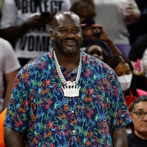Former NBA player Shaquille O'Neal and Chicago Bulls 2024 NBA draft pick Matas Buzelis stand on the sidelines before a basketball game between the Chicago Sky and Indiana Fever at Wintrust Arena.