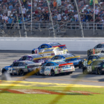 Ryan Blaney (12) crosses into Ross Chastain (1) creating a wreck in the final laps during the second stage of the YellaWood 500 at Talladega Superspeedway.