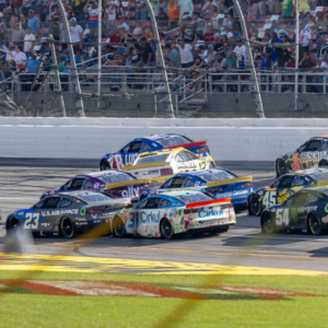 Ryan Blaney (12) crosses into Ross Chastain (1) creating a wreck in the final laps during the second stage of the YellaWood 500 at Talladega Superspeedway.