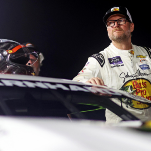 Dale Earnhardt Jr. waits next to his during qualifying for the 16th Annual Hampton Heat at Langley Speedway.