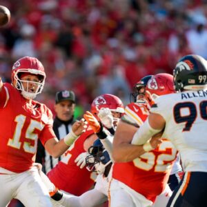Kansas City Chiefs quarterback Patrick Mahomes (15) throws a pass against Denver Broncos defensive end Zach Allen (99) during the second half at GEHA Field at Arrowhead Stadium.