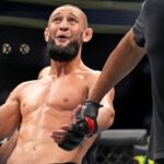 Khamzat Chimaev (red gloves) fights Kevin Holland (blue gloves) during UFC 279 at T-Mobile Arena.
