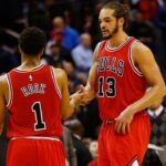 Chicago Bulls guard Derrick Rose (1) celebrates with Bulls center Joakim Noah (13) against the Washington Wizards in the fourth quarter at Verizon Center. The Bulls won 99-91.