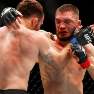 Serhiy Sidey (red gloves) fights Garrett Armfield (blue gloves) in a bantamweight bout during UFC Fight Night at Rogers Place.