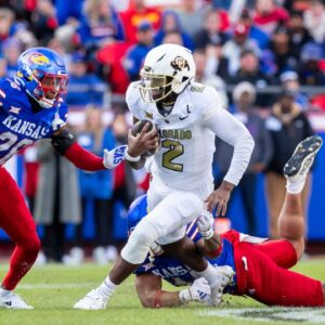 Kansas City, Missouri, USA; Colorado quarterback Shedeur Sanders (2) scrambles for yardage during the 2nd quarter between the Kansas Jayhawks and the Colorado Buffaloes at GEHA Field at Arrowhead Stadium.