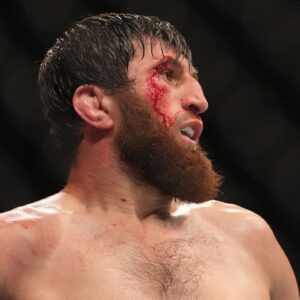 Magomed Ankalaev (blue gloves) reacts during the fight against Jan Blachowicz (red gloves) during UFC 282 at T-Mobile Arena.