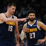 Apr 10, 2024; Denver, Colorado, USA; Denver Nuggets center Nikola Jokic (15) and guard Jamal Murray (27) talk in the fourth quarter against the Minnesota Timberwolves at Ball Arena. Mandatory Credit: Ron Chenoy-Imagn Images