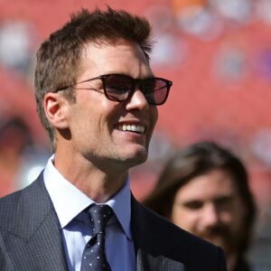 NFL legend Tom Brady is all smiles before an NFL football game at Huntington Bank Field, Sunday, Sept. 8, 2024, in Cleveland, Ohio.
