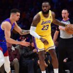 Los Angeles Lakers forward LeBron James (23) controls the ball against Denver Nuggets forward Michael Porter Jr. (1) during the first half in game three of the first round for the 2024 NBA playoffs at Crypto.com Arena