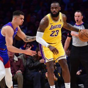 Los Angeles Lakers forward LeBron James (23) controls the ball against Denver Nuggets forward Michael Porter Jr. (1) during the first half in game three of the first round for the 2024 NBA playoffs at Crypto.com Arena