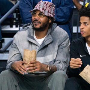 Carmelo Anthony and his son, Kiyan, watch the Don Bosco Prep Ironmen compete against the McEachern Indians in a game during the 50th annual City of Palms Classic at Suncoast Credit Union Arena in Fort Myers on Tuesday, Dec. 19, 2023. Kiyan Anthony and the Long Island Luthern Crusaders defeated Westminster Academy earlier in the day.