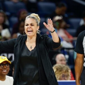 Las Vegas Aces head coach Becky Hammon (L) argues a call against her team with official Tim Greene (R) during the first half of a basketball game against the Chicago Sky at Wintrust Arena