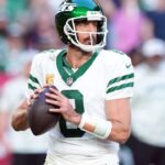 New York Jets quarterback Aaron Rodgers (8) passes against the Arizona Cardinals during the second half at State Farm Stadium.