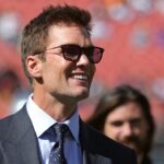 NFL legend Tom Brady is all smiles before an NFL football game at Huntington Bank Field,