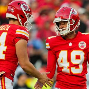 Kansas City Chiefs place kicker Matthew Wright (49) celebrates with punter Matt Araiza (14) after kicking a field goal during the second half against the Las Vegas Raiders at GEHA Field at Arrowhead Stadium.