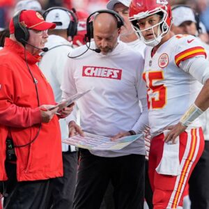 Kansas City Chiefs head coach Andy Reid talks with quarterback Patrick Mahomes (15) during a time out during the second half against the Carolina Panthers at Bank of America Stadium.