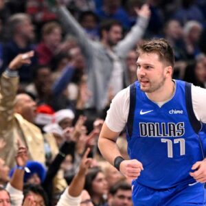 Dallas Mavericks guard Luka Doncic (77) celebrates after making a basket against the Minnesota Timberwolves during the first quarter at the American Airlines Center.