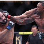 Michael Johnson (red gloves) fights Ottman Azaitar (blue gloves) at Amalie Arena.