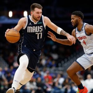 Dallas Mavericks guard Luka Doncic (77) drives to the basket as Washington Wizards guard Jared Butler (4) defends in the second quarter at Capital One Arena.