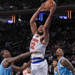 New York Knicks center Karl-Anthony Towns (32) shoots the ball while being defended by Charlotte Hornets forward Moussa Diabate (14) and Charlotte Hornets guard DaQuan Jeffries (3) during the second half at Madison Square Garden.