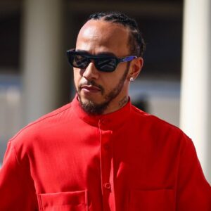 Lewis Hamilton of Mercedes dressed all in red arrives on the paddock on a race day of Formula 1 Abu Dhabi Grand Prix at Yas Marina Circuit
