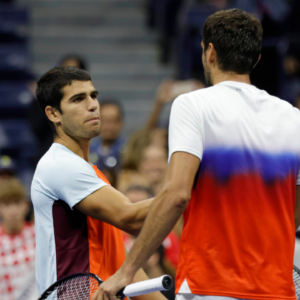 Carlos Alcaraz (ESP) (L) shakes hands with Marin Cilic (CRO) (R) after their match on day eight of the 2022 U.S. Open
