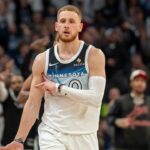 Minnesota Timberwolves guard Donte DiVincenzo (0) celebrates after making a shot against the San Antonio Spurs in the second half at Target Center.
