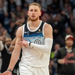 Minnesota Timberwolves guard Donte DiVincenzo (0) celebrates after making a shot against the San Antonio Spurs in the second half at Target Center.