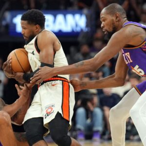 Phoenix Suns guard Bradley Beal (3) and Phoenix Suns forward Kevin Durant (35) attempt to tie up Detroit Pistons guard Malik Beasley (5) during the second half at Footprint Center.