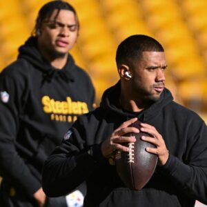 Pittsburgh Steelers quarterback Russell Wilson throws the ball as Justin Fields looks during warm ups for a game against the Cleveland Browns at Acrisure Stadium.
