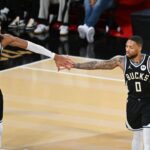 Milwaukee Bucks guard Damian Lillard (0) and forward Giannis Antetokounmpo (34) react during the fourth quarter against the Atlanta Hawks in a semifinal of the 2024 Emirates NBA Cup at T-Mobile Arena.
