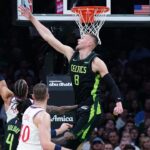 Boston Celtics center Kristaps Porzingis (8) defends against LA Clippers guard Amir Coffey (7) in the first quarter at TD Garden.