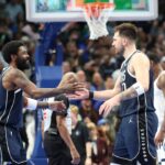 Dallas Mavericks guard Kyrie Irving (11) celebrates with Dallas Mavericks guard Luka Doncic (77) during the fourth quarter against the Memphis Grizzlies at American Airlines Center.