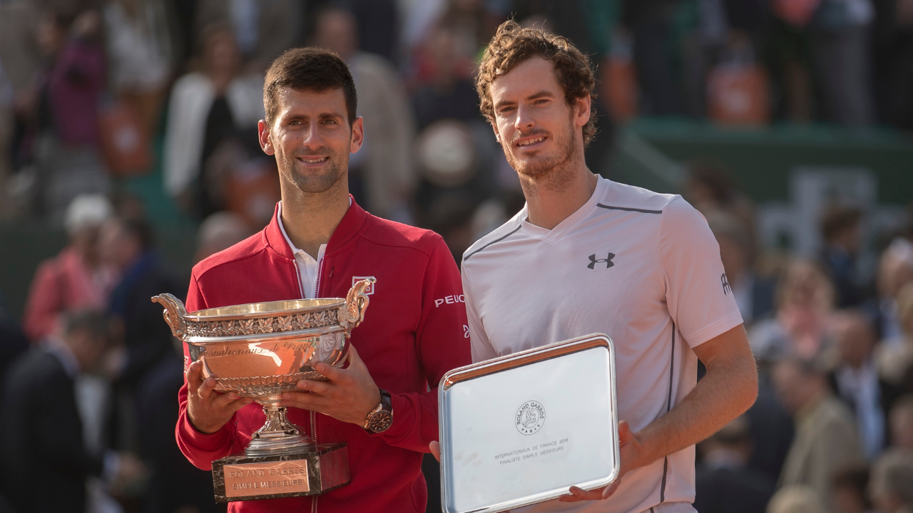 Novak Djokovic (SRB) and Andy Murray (GBR) pose with their trophies at the presentation on day 15 of the 2016 French Open