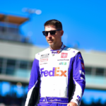 Nov 10, 2024; Avondale, Arizona, USA; NASCAR Cup Series driver Denny Hamlin (11) is introduced before the Cup Series championship race at Phoenix Raceway. Mandatory Credit: Gary A. Vasquez-Imagn Images