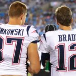 Aug 24, 2018; Charlotte, NC, USA; New England Patriots tight end Rob Gronkowski (87) talks with quarterback Tom Brady (12) during the fourth quarter against the Carolina Panthers at Bank of America Stadium.