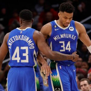Milwaukee Bucks forward Giannis Antetokounmpo (34) hugs his brother, Bucks forward Thanasis Antetokounmpo (43), while walking off the floor against the Washington Wizards in the fourth quarter at Capital One Arena.