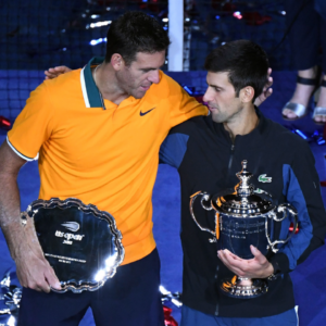 Juan Martin Del Potro of Argentina and Novak Djokovic of Serbia poses with the runner-up and championship trophies (respectively) on day fourteen of the 2018 U.S. Open tennis tournament