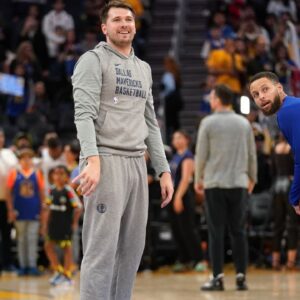 Dallas Mavericks guard Luka Doncic (77) and Golden State Warriors guard Stephen Curry (30) stand on the court during warmups at the Chase Center.