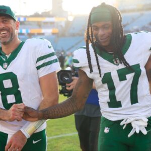 New York Jets quarterback Aaron Rodgers (8) and wide receiver Davante Adams (17) high-five each other as they walks off the field after the game Sunday, Dec. 15, 2024 at EverBank Stadium in Jacksonville, Fla. The Jets held off the Jaguars 32-25.