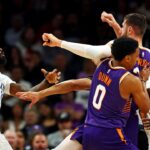 Dallas Mavericks forward Naji Marshall (13) punches Phoenix Suns center Jusuf Nurkic (20) during the third quarter at Footprint Center.