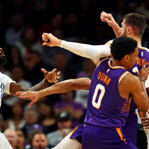Dallas Mavericks forward Naji Marshall (13) punches Phoenix Suns center Jusuf Nurkic (20) during the third quarter at Footprint Center.