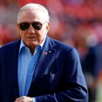 Dallas Cowboys owner Jerry Jones walks off the field before the game between the Washington Commanders and the Dallas Cowboys at Northwest Stadium.