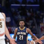 New Orleans Pelicans center Yves Missi (21) celebrates a basket with New Orleans Pelicans guard CJ McCollum (3) as Denver Nuggets center Nikola Jokic (15) reacts during overtime at Smoothie King Center.