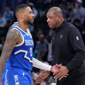 Milwaukee Bucks head coach Doc Rivers congratulates Milwaukee Bucks guard Damian Lillard (0) in the second half at Fiserv Forum.