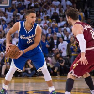 Golden State Warriors guard Stephen Curry (30) controls the basketball against Cleveland Cavaliers guard Matthew Dellavedova (8) during the fourth quarter in a NBA basketball game on Christmas at Oracle Arena. The Warriors defeated the Cavaliers 89-83.