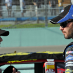 NASCAR Sprint Cup Series drivers Jeff Gordon (left) talks to Jimmie Johnson (right) during qualifying for the Ford 400 at Homestead Miami Speedway.