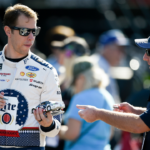 Monster Energy NASCAR Cup Series driver Brad Keselowski (2) autographs a fan's miniature car during practice for the Can-Am 500 at ISM Raceway.